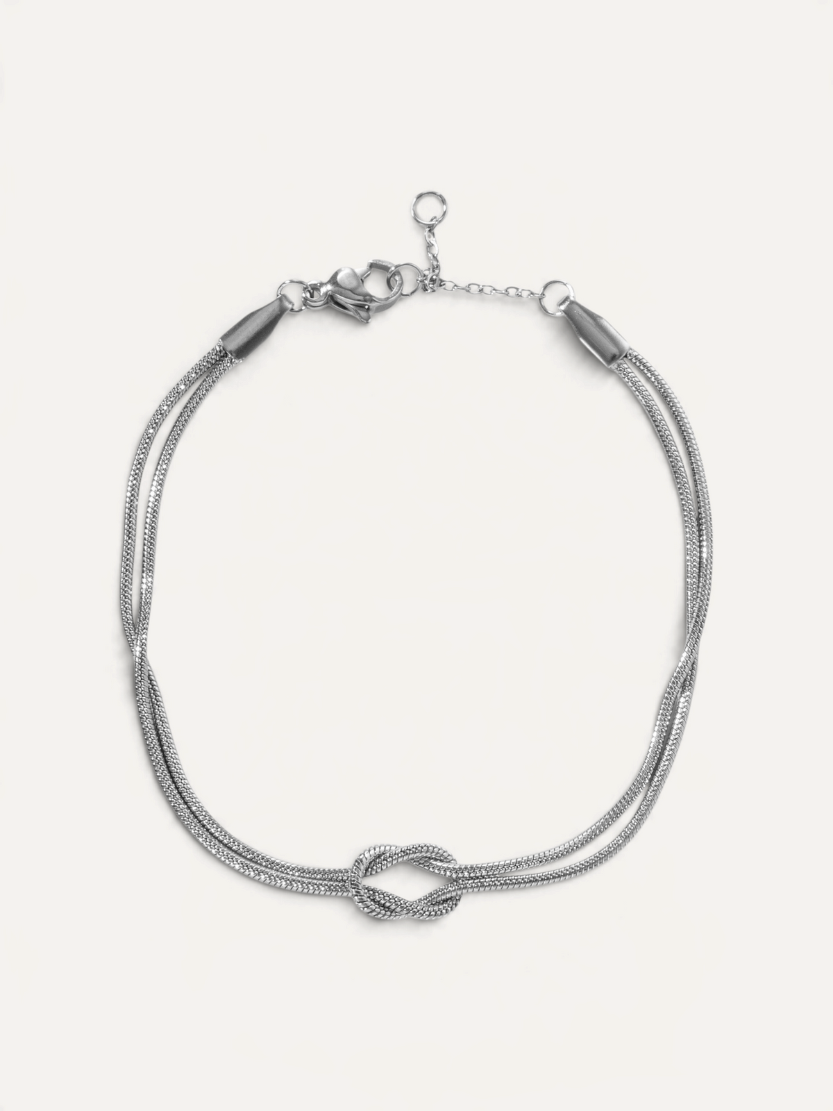 CÉLOIR Saphera Armband aus silberfarbenem Edelstahl mit elegantem Knoten-Detail und verstellbarer Kette