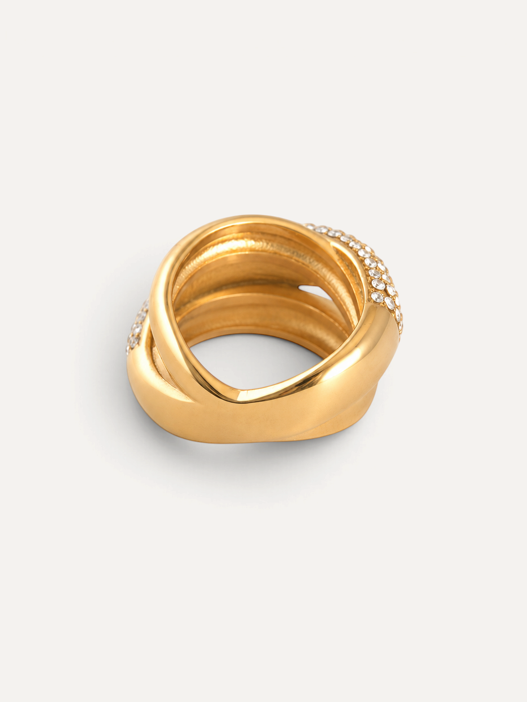 CÉLOIR LIVIA Ring aus goldfarbenem Edelstahl mit funkelnden Zirkonia-Steinen in geschwungenem Design
